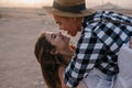 Portrait of smiling couple having fun in travel around country posing on blur background. Laughing boy in checkered