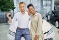 Portrait of smiling couple with keys from their new auto Royalty Free Stock Photo