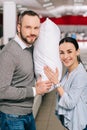 portrait of smiling couple with pillow