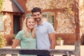 Portrait Of Smiling Couple Standing By Gate Outside Home In Countryside Together Royalty Free Stock Photo