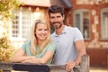 Portrait Of Smiling Couple Standing By Gate Outside Home In Countryside Together Royalty Free Stock Photo