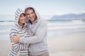 Portrait of smiling couple wearing hooded sweater during winter