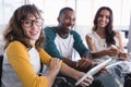 Portrait of smiling creative business colleagues using digital tablet Royalty Free Stock Photo