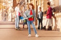 Happy curly-haired teenage boy holding skateboard Royalty Free Stock Photo