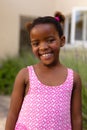 Portrait of smiling cute african american girl wearing pink sleeveless top