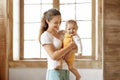 Portrait of smiling cute baby and happy mother at home Royalty Free Stock Photo