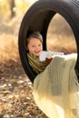 Portrait of smiling cute boy with big red apple and book in swing wheel Royalty Free Stock Photo