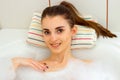 Portrait of smiling cute Brunettes that lies in the bath with foam Royalty Free Stock Photo