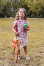 Portrait of smiling cute little girl playing with an old tennis racket Royalty Free Stock Photo