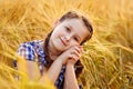 Portrait of a smiling cute little girl in a wheat field in the open air. Nature in the village Royalty Free Stock Photo