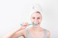 Portrait of a smiling cute woman holding toothbrush snd cleaning tooth isolated on a white background