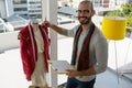 Portrait of smiling designer holding clipboard standing by mannequin Royalty Free Stock Photo