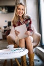 Portrait of a smiling designer, student, freelancer business woman using tablet computer