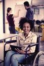 Portrait of smiling disabled business executive in wheelchair using digital tablet Royalty Free Stock Photo