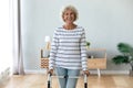 Portrait smiling disabled older woman standing with walker