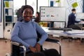 Portrait of smiling disabled paralyzed african american businesswoman in wheelchair Royalty Free Stock Photo
