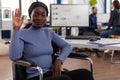 Portrait of smiling disabled paralyzed african american businesswoman in wheelchair Royalty Free Stock Photo