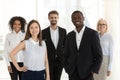 Portrait of smiling diverse work team standing posing in office Royalty Free Stock Photo