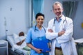 Portrait of smiling doctor and nurse in ward Royalty Free Stock Photo