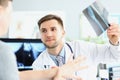 Smiling doctor talking with patient about good x ray results Royalty Free Stock Photo