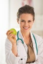 Portrait of smiling doctor woman with apple
