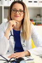 Happy adult female doctor at her workplace Royalty Free Stock Photo