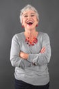 Portrait of smiling elderly lady in gray Royalty Free Stock Photo