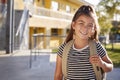 Portrait of smiling elementary school girl with her backpack Royalty Free Stock Photo