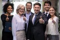 Portrait of smiling employees show thumbs up Royalty Free Stock Photo