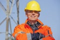 Portrait of a smiling engineer, foreman or worker with protective clothing and hard hat
