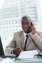 Portrait of a smiling entrepreneur making a phone call while reading a document Royalty Free Stock Photo