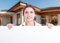 Portrait of smiling estate consultant holding empty banner