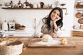 Portrait of smiling european woman making homemade pasta of dough in kitchen at home Royalty Free Stock Photo