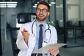 Portrait of smiling excited doctor in hospital