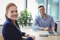 Portrait of smiling executives sitting at desk Royalty Free Stock Photo