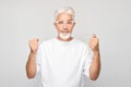 Portrait of smiling face gray-haired man clenching fists and rejoicing, celebrating victory Royalty Free Stock Photo