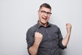 Portrait of smiling face man clenching fists and rejoicing, celebrating victory isolated on white studio background Royalty Free Stock Photo