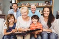 Portrait of smiling family with grandparents holding photo album Royalty Free Stock Photo