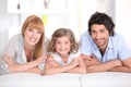 Portrait of a smiling family laid on a bed