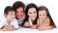 Portrait of a smiling family lying on bed Royalty Free Stock Photo