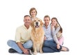 Portrait of smiling family sitting together with their dog Royalty Free Stock Photo