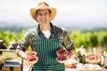 Portrait of a smiling farmer holding bowls of strawberries