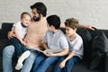 portrait of smiling father and sons reading book together Royalty Free Stock Photo