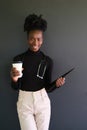 Smiling female african medical student with stethoscope, folders and a coffee. Royalty Free Stock Photo