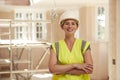 Portrait Of Smiling Female Builder Wearing Hard Hat Working In New Build Property Royalty Free Stock Photo