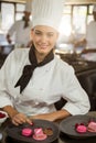 Portrait of smiling female chef finishing dessert plates Royalty Free Stock Photo