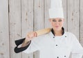 Portrait of smiling female chef holding rolling pin Royalty Free Stock Photo