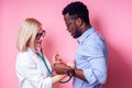Portrait of a smiling female doctor with afro american patient man.beautiful blonde woman white medical coat and glasses