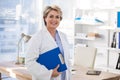 Portrait of a smiling female doctor holding clipboard Royalty Free Stock Photo