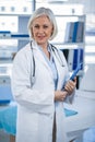 Portrait of a smiling female doctor holding clipboard Royalty Free Stock Photo